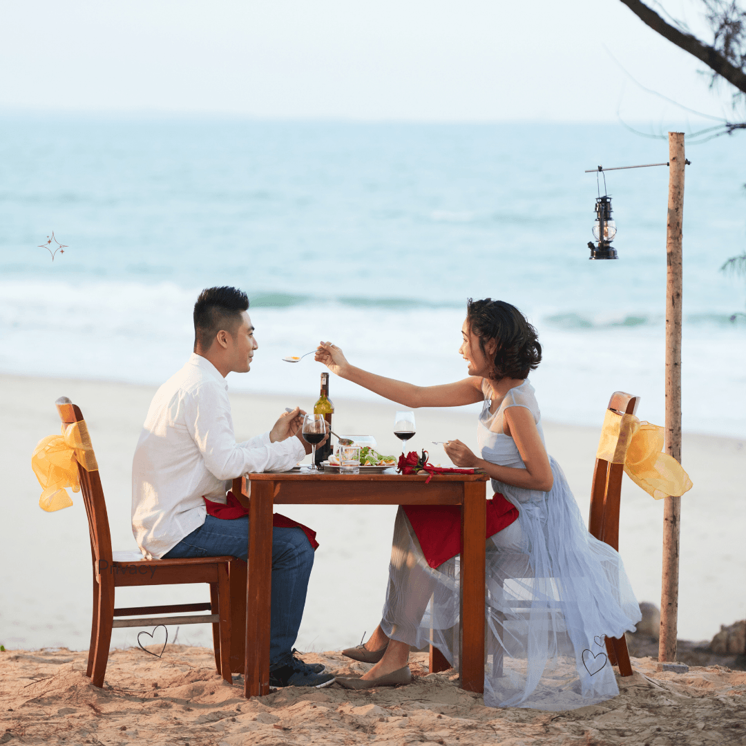 Couple celebrating their honeymoon by the sea at sunset